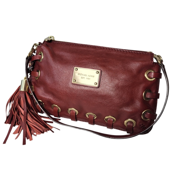 Michael Kors red leather clutch with grommets and tassels